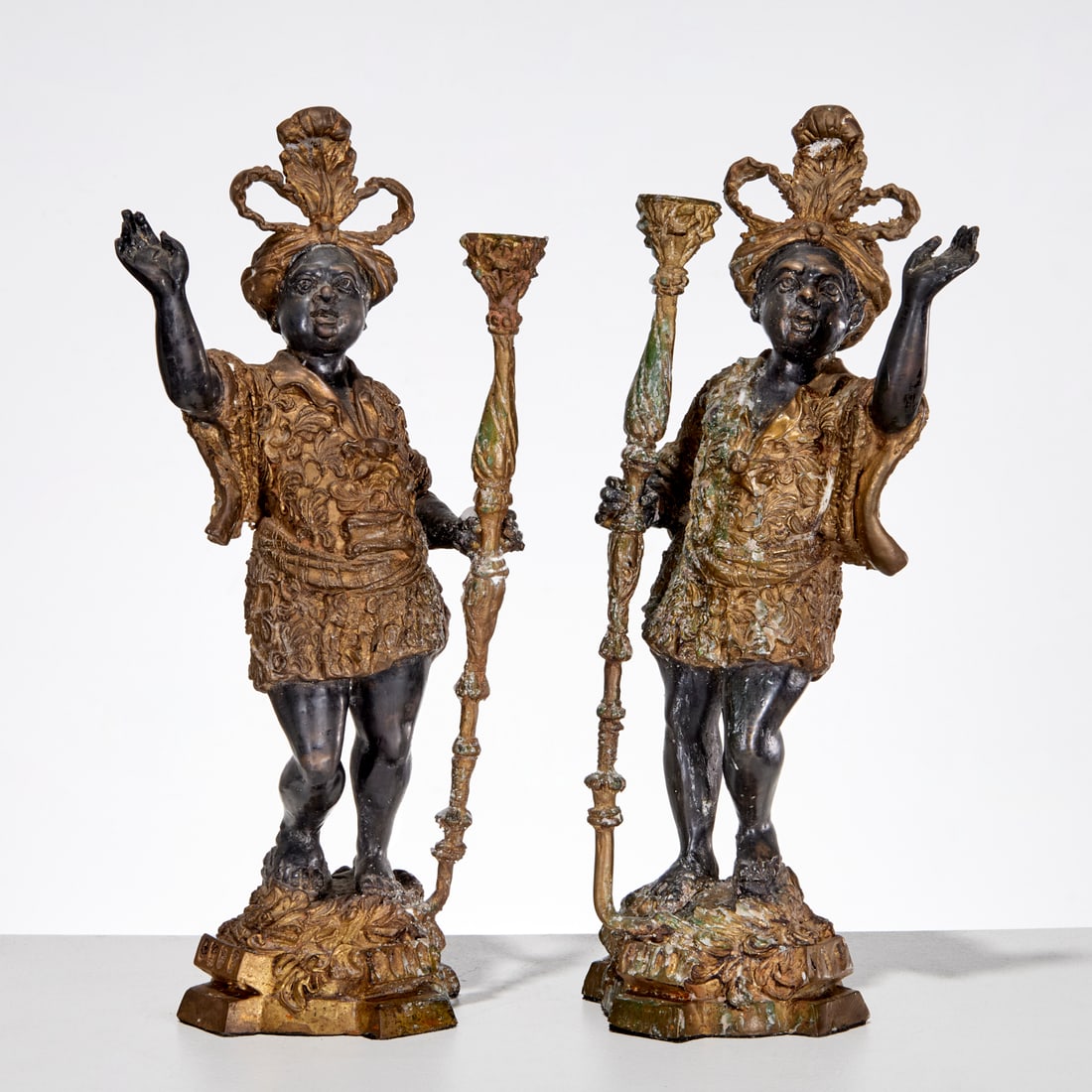 Pair Orientalist style figural candlesticks: Pair Orientalist style figural candlesticks, 20th c., gilt and patinated copper alloy, figures in Venetian dress holding torchiere form candlesticks, unmarked, each 17"h x 7"w x 5"d