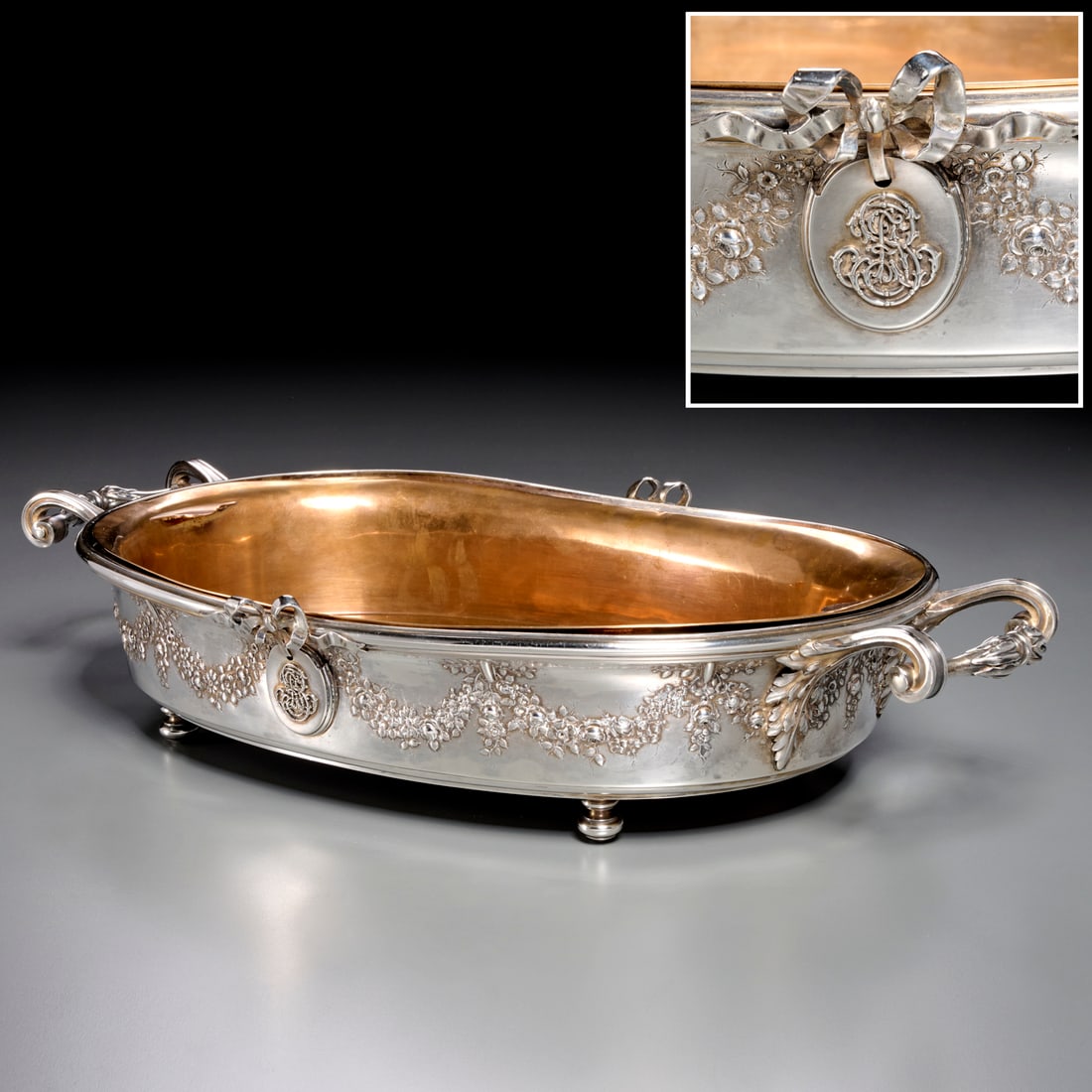 Gustave Keller, French silver centerpiece bowl: Gustave Keller, French silver centerpiece bowl, c. 1890, Paris, Gustave Keller, oval form with foliate scroll handles, chased with floral garland in the round, monogrammed medallion with ribbon crest,