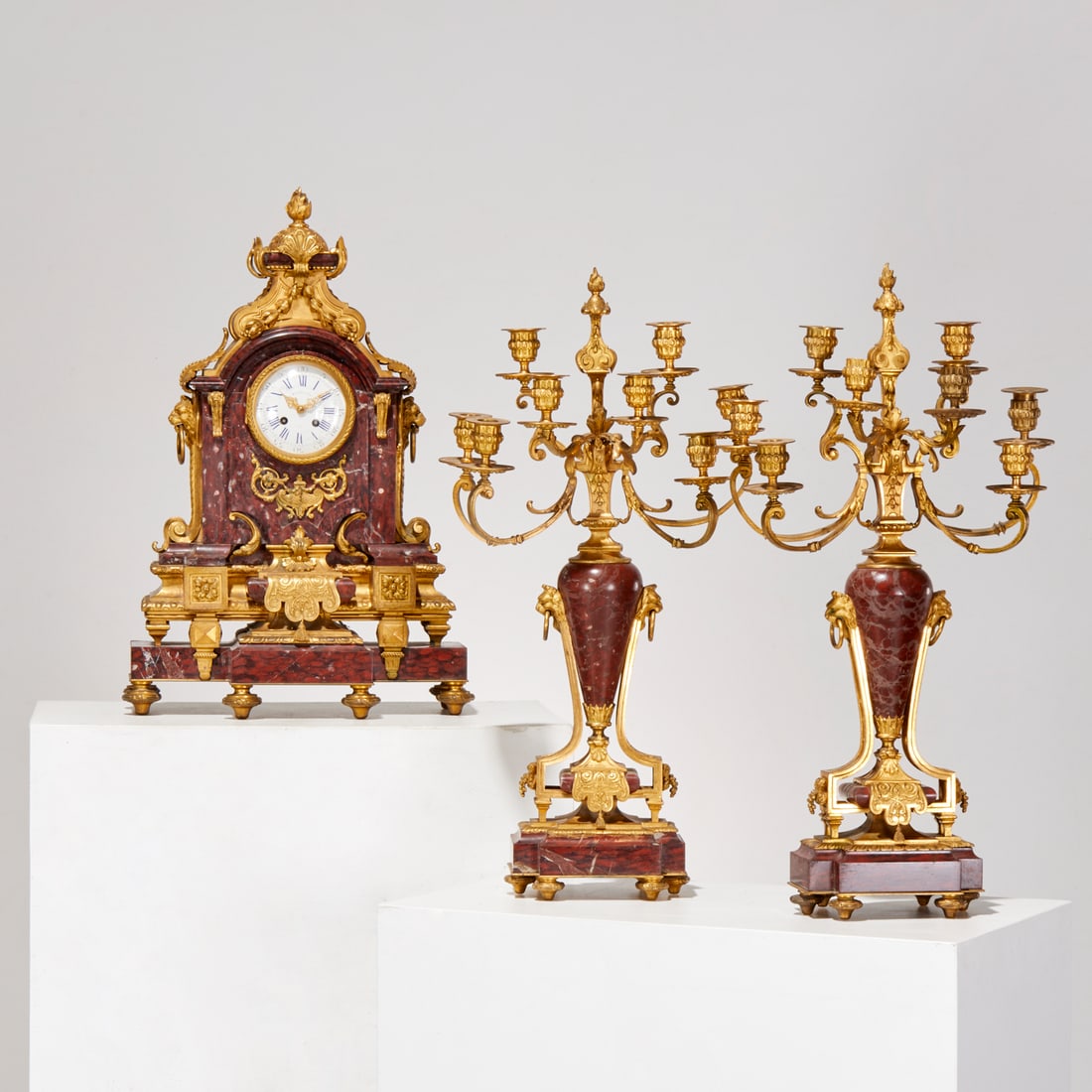 Napoleon III clock garniture, ex Christie's: Napoleon III clock garniture, ex Christie's, Late 19th c., France, by Raingo Freres, Paris, ormolu and rouge griotte marble three-piece garniture, striking mantel clock and pair of eight-light candela
