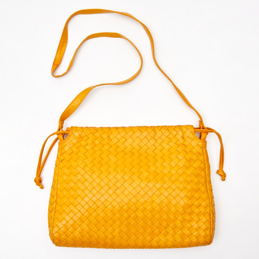 Bottega Veneta tangerine Intrecciato shoulder bag: Bottega Veneta tangerine Intrecciato shoulder bag, 20th c., Made in Italy, long single shoulder strap which can be tied to shorten, snap closure, side drawstrings, interior with zipper pocket, mirror 