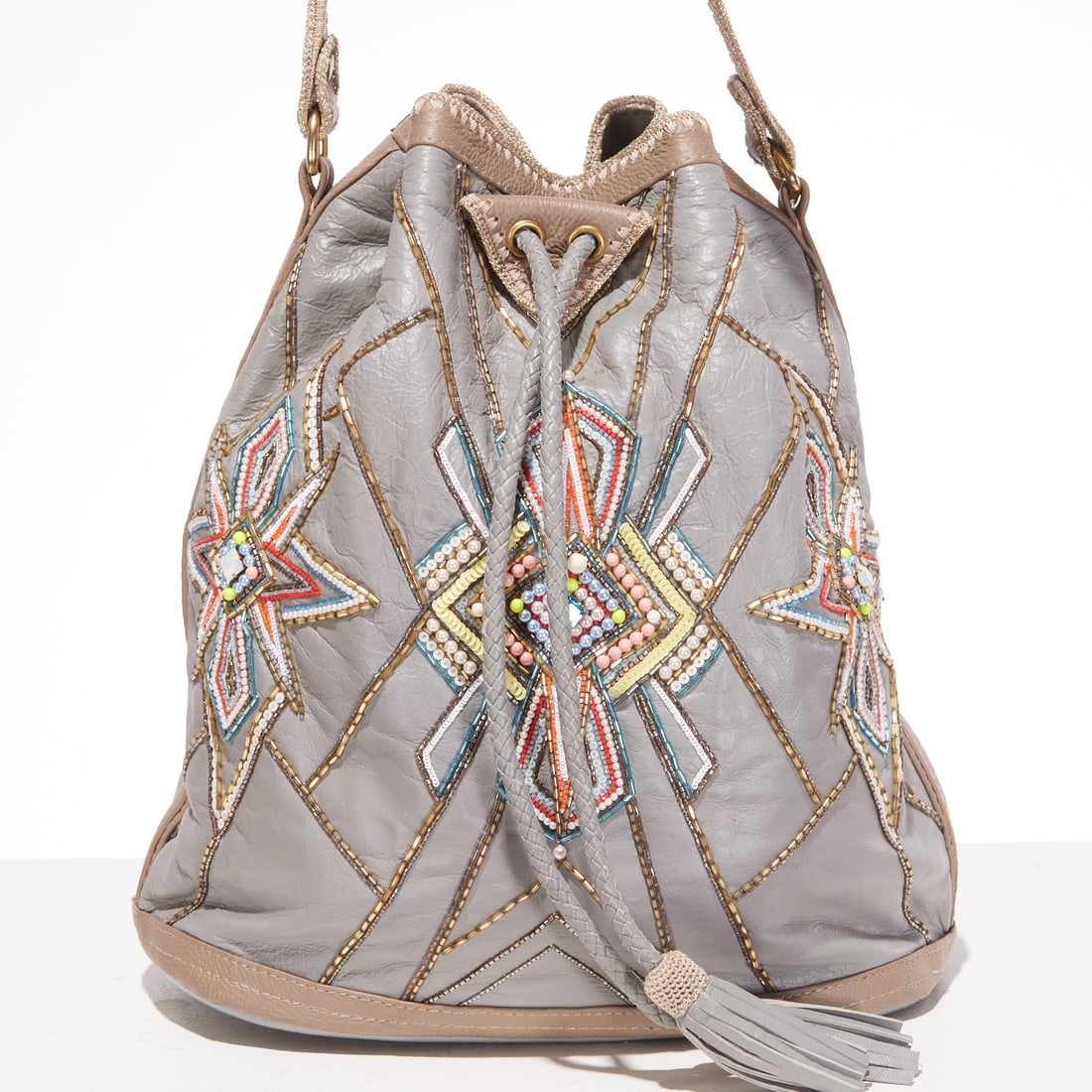 Buba London beaded bucket bag: Buba London beaded bucket bag, 21st c., in gray blue leather, drawstring closure, adjustable strap, embroidered with Japanese beads, interior in soft fabric with moleskin texture, zipper pocket, appro