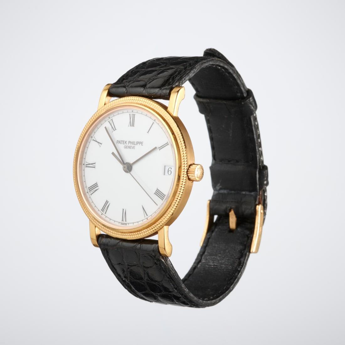 Patek Philippe 18k Calatrava wristwatch: Patek Philippe 18k Calatrava wristwatch, 1990s Made in France, Rose Gold. leather strap, white porcelain face, Roman Numeral hands, 3802/200, with Certificate of Origin Provenance: A Private Collectio