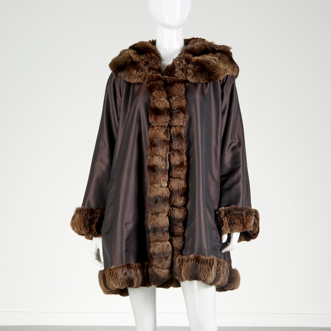 Fendi Reversible chinchilla trim swing coat: Fendi Reversible chinchilla trim swing coat, 21st c., Made in Italy, brown cashmere reverses to all weather fabric, Fendi logo buttons, shorter style, size M/L, 40"5, 35"l, 26"sl Provenance: From the