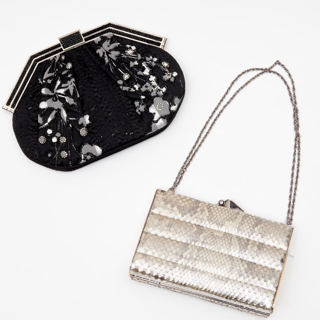 Two embellished evening bags, incl. Leiber: Two embellished evening bags, incl. Leiber, 20th c., (1) Judith Leiber heavy black fabric with silver & black floral design and beads, silver metal frame adorned with sparkly black beads, latch over c