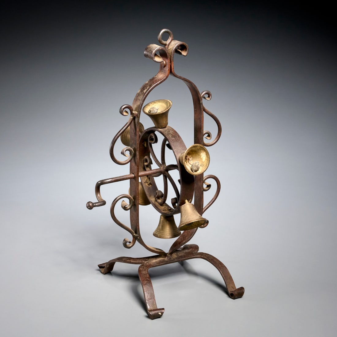 Antique wrought iron and brass rotary doorbells: Antique wrought iron and brass rotary doorbells, 19th/20th c., central iron wheel with 6 brass bells, 15.75"h x 9"l x 8.5"d Provenance: The Iris Apfel Collection