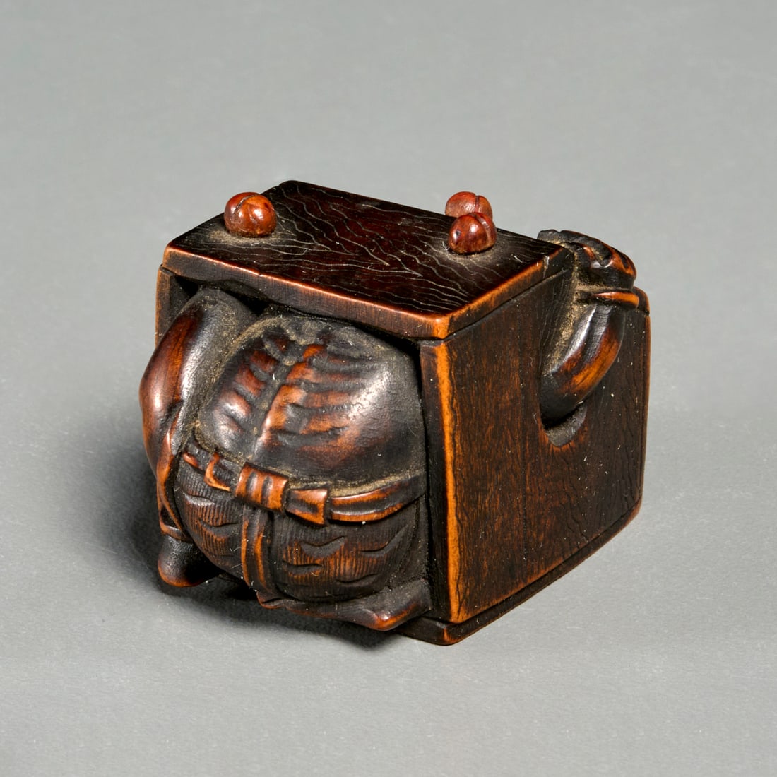 Meiji Period boxwood Oni netsuke: Meiji Period boxwood Oni netsuke, 19th/20th c., Oni inside a box, 1"h x 1.5"w x 1"d Provenance: The Estate of Mary Travers, NY