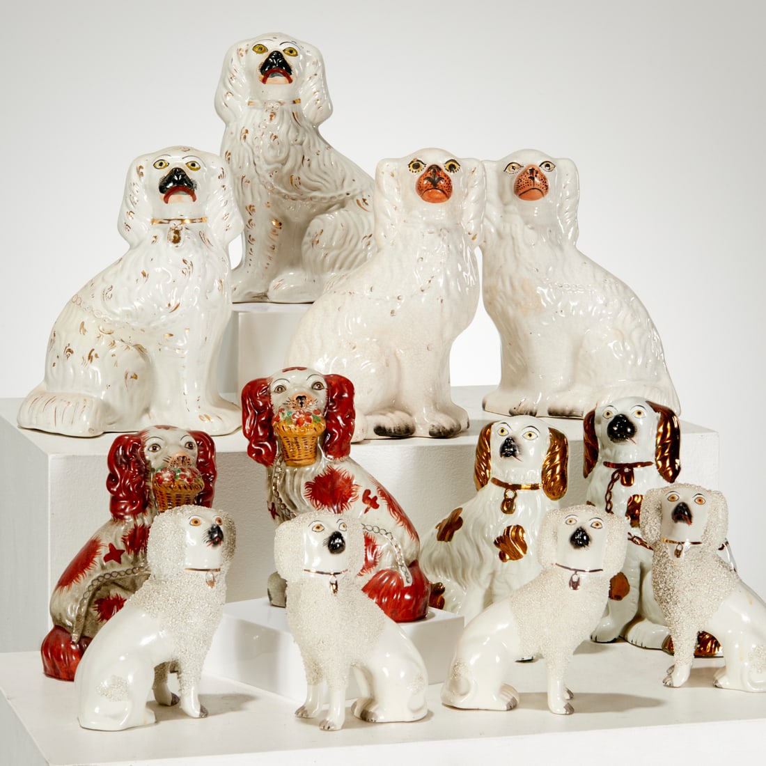 Staffordshire Spaniel collection: Staffordshire Spaniel collection, 19th/20th c., (12) pieces, incl. (1) pair lustre glaze, (2) pairs textured glaze, (2) pairs white glaze, (1) pair red glaze with flower basket, (2) pairs marked under