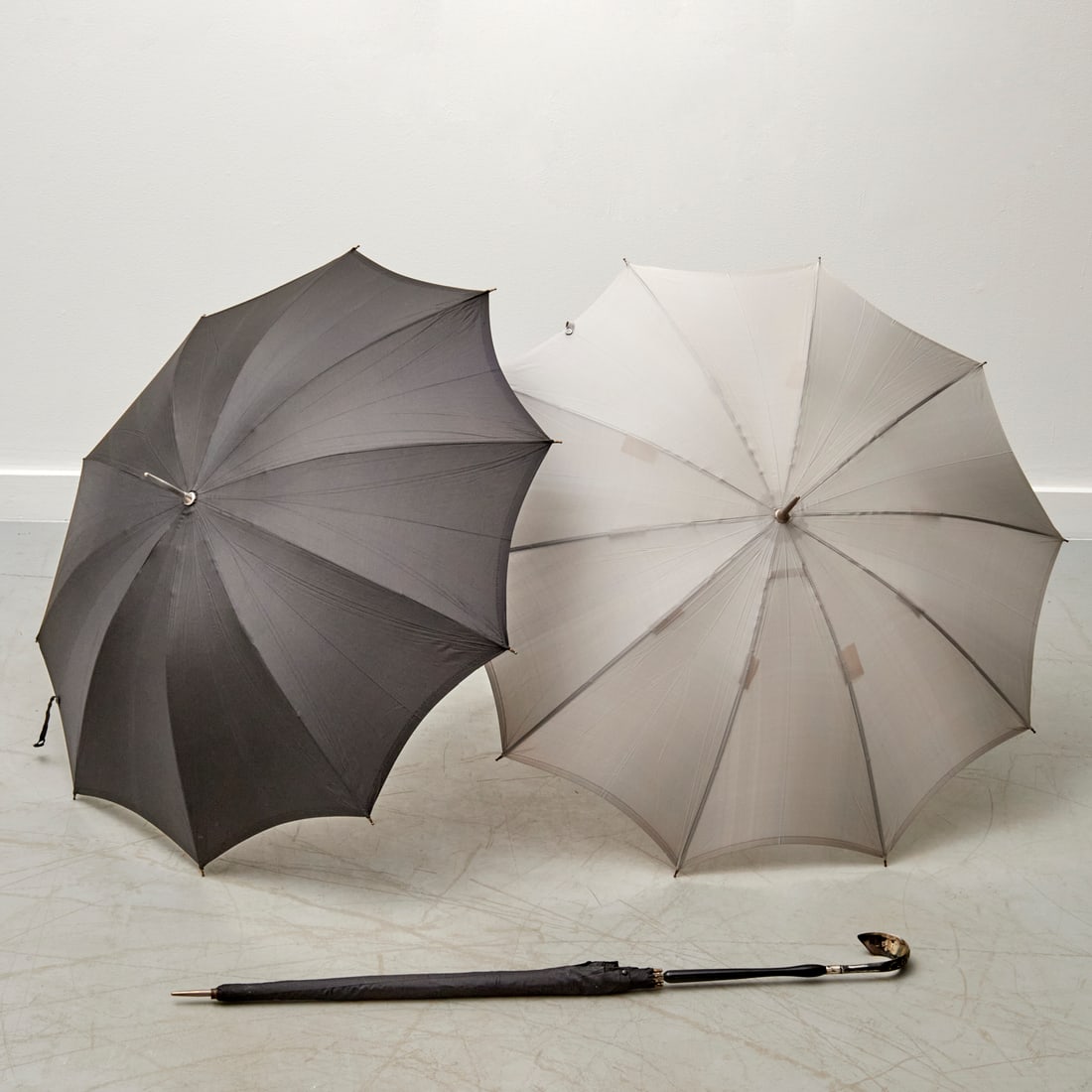 (3) Vintage Italian silver-handled parasols: (3) Vintage Italian silver-handled parasols, 20th c., Fraclem-Florence tags, silver handles stamped "800", with original sheaths, pair with matching handles at 34.5"l, one at 35.5"l Provenance: A Priv