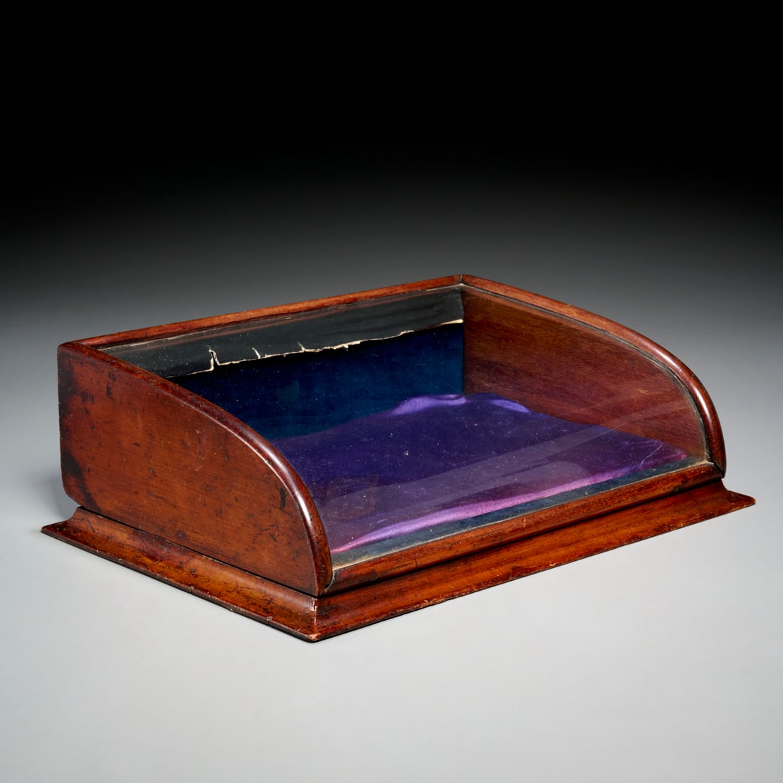 Victorian curved-glass tabletop display case: Victorian curved-glass tabletop display case, 19th c., English or American, opens at the back with a brass spring latch, removable velvet covered wood tray, 4.75"h x 15"w x 10.5"d Provenance: The