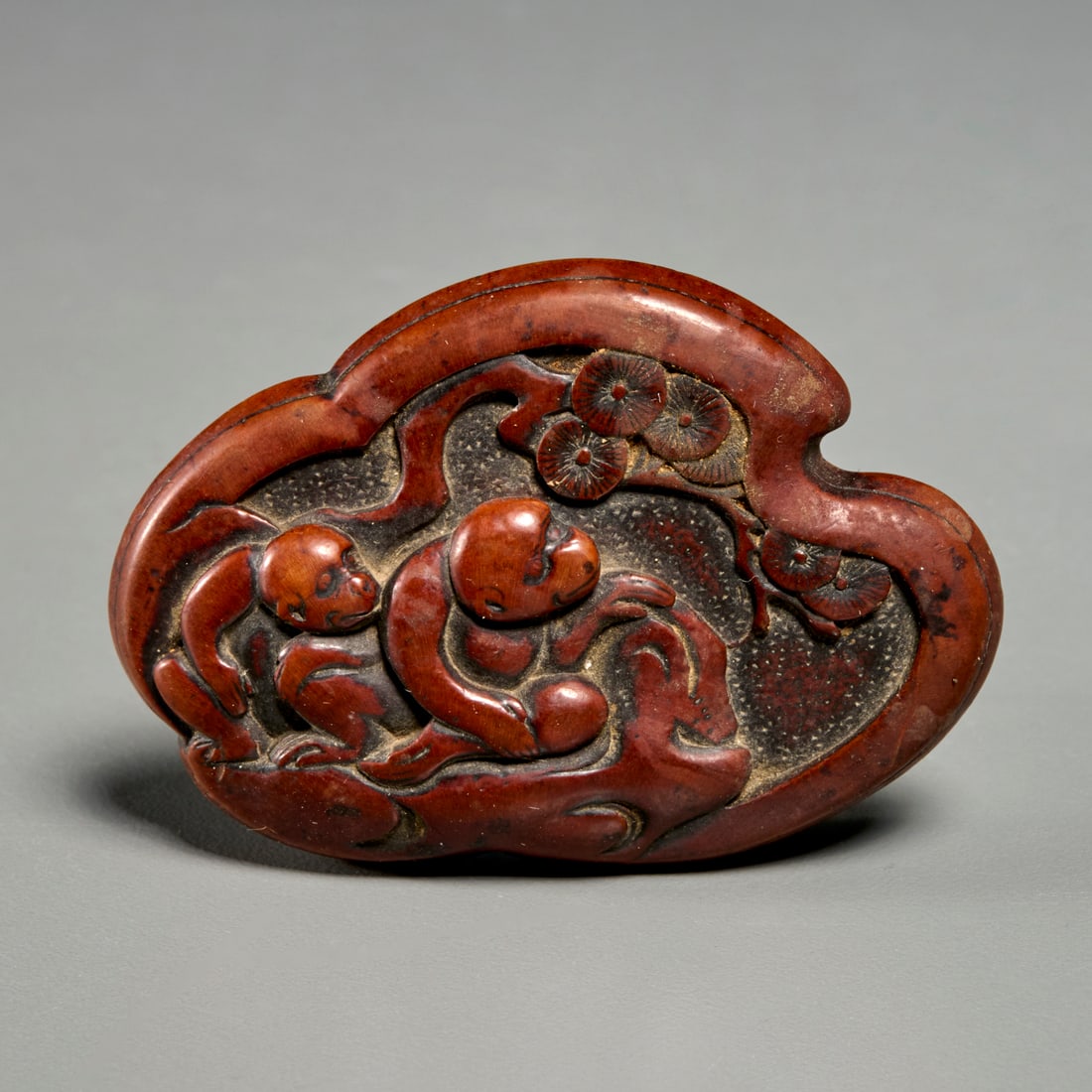 Edo or Meiji Period manju netsuke: Edo or Meiji Period manju netsuke, 19th c. or earlier, carved wood, depicting two monkeys and flowering trees, unsigned, 2.25"l x 1.5"w Provenance: The Estate of Mary Travers, NY