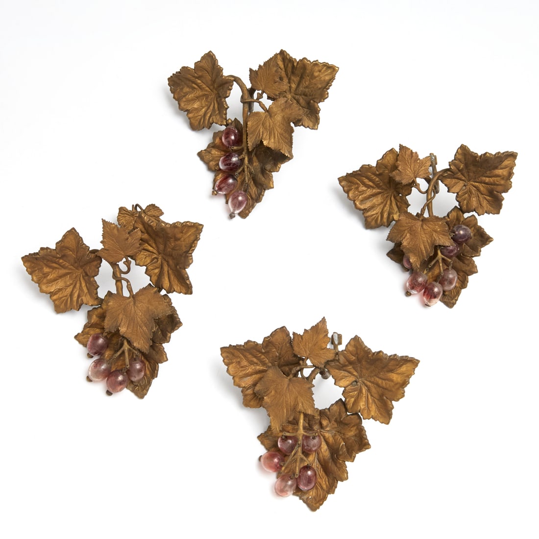 Set (4) Victorian grape cluster drapery tiebacks: Set (4) Victorian grape cluster drapery tiebacks, 19th c., brass leaves and vines with purple glass grapes, 10"h x 10"w x 6"d Provenance: The Iris Apfel Collection