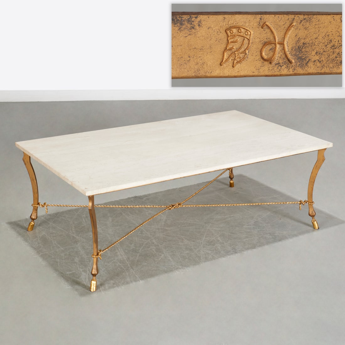 Ramsay (style) gilt iron coffee table, signed: Ramsay (style) gilt iron coffee table, signed, Mid 20th c., rectangular travertine top on cabriole legs with hoof feet joined by rope twist and knotted stretcher, unidentified monogram and winged
