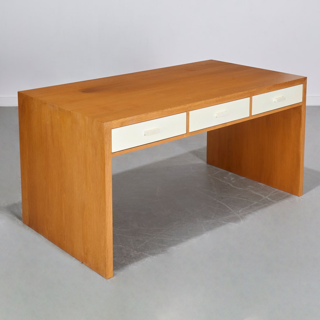 J.M. Frank style, oak desk, Peter Marino: J.M. Frank style, oak desk, Peter Marino, 21st c., designed by Peter Marino, waterfall style with three white parchment wrapped two drawer faces, unmarked, 30"h x 60"w x 32"d Provenance: A Peter Marin