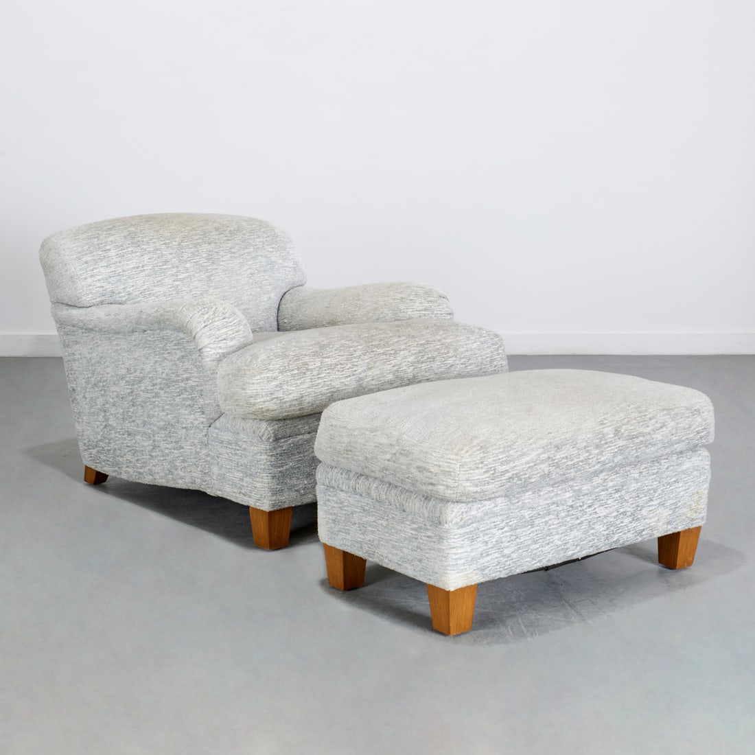 J.M. Frank style, chair and ottoman, Peter Marino: J.M. Frank style, chair and ottoman, Peter Marino, 21st c., designed by Peter Marino, in Jean Michel Frank's "Bridgewater" style, gray upholstery, 27"h x 31"w x 41"d (chair), 17"h x 32"w x 20"d (ottom