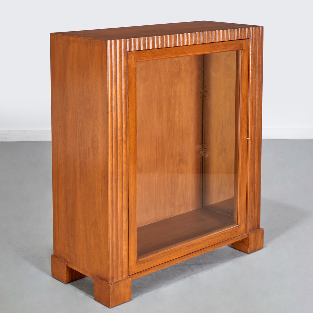Peter Marino designed display vitrine: Peter Marino designed display vitrine, 21st c., fluted walnut case with single glazed panel door on block feet, electrified, 44.25"h x 38"w x 16"d Provenance: A Peter Marino Private Commission: