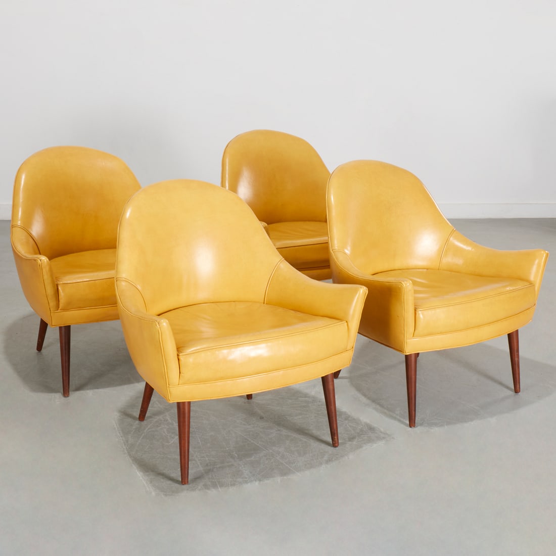 Paul McCobb (style), set (4) lounge chairs: Paul McCobb (style), set (4) lounge chairs, Mid 20th c., Symmetric style, with butter yellow vinyl upholstery, on round tapering legs, unmarked, each 30"h x 28"w x 23"d Provenance: A Private Collectio
