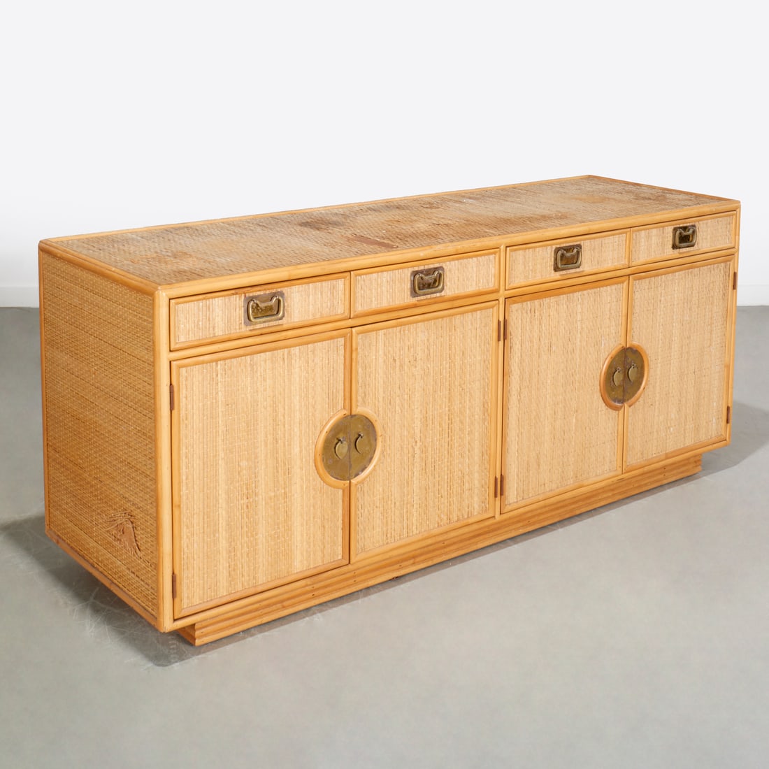 Bielecky Bros. style bamboo and rattan credenza: Bielecky Bros. style bamboo and rattan credenza, c. 1970s, four drawers with double door panels revealing interior shelves, brass pulls, unmarked, 32"h x 74"w x 24"d Provenance: A Private Collection: 