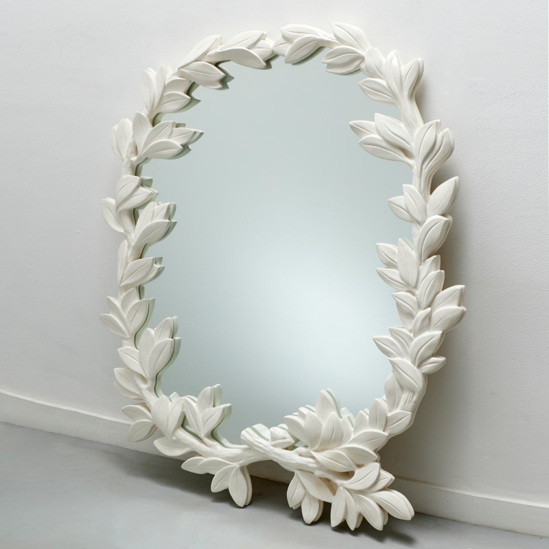 Serge Roche (manner), large wall mirror: Serge Roche (manner), large wall mirror, 20th c., molded composition, oval mirror plate with bold laurel branch and leaf surround, unmarked, approx. 58"h x 46"w Provenance: A Private Collection: