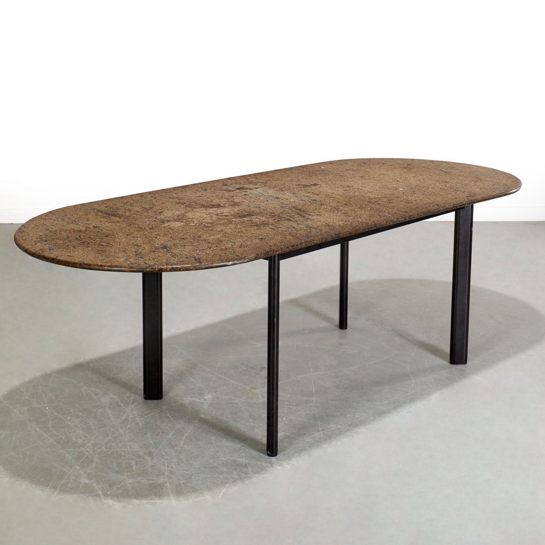 Joseph d'Urso for Knoll, racetrack dining table: Joseph d'Urso for Knoll, racetrack dining table, Late 20th c., granite top, raised on black enamel finish steel base, marked interior frame, 28"h x 84"l x 35.5"w Provenance: Property from the Estate o