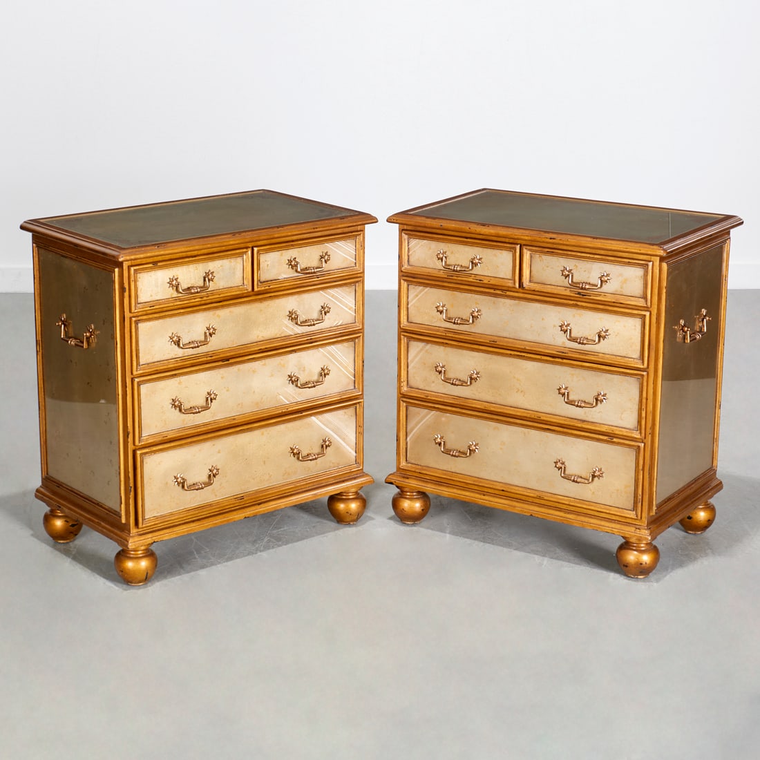 Pair Theodore Alexander eglomise chests: Pair Theodore Alexander eglomise chests, Late 20th c., USA, giltwood molded case with five graduated drawers with brass pulls, on ball feet, maker's placard to drawer interior, each 30"h x 27.25"w x 1