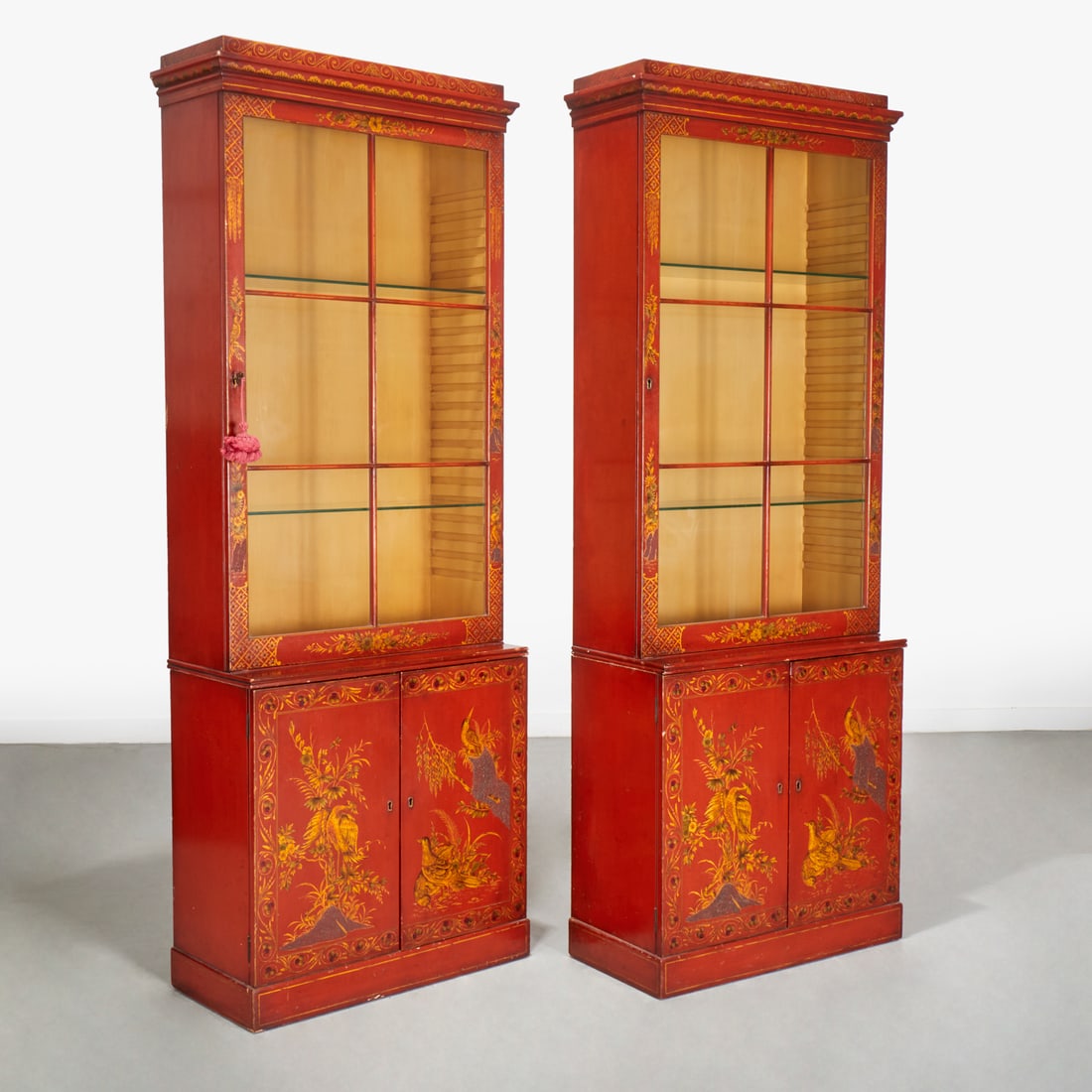Pair George III style scarlet japanned cabinets: Pair George III style scarlet japanned cabinets, First half 20th c., in two parts, each upper section with glass paned doors opening to interior shelves, the bases with cupboard doors opening to