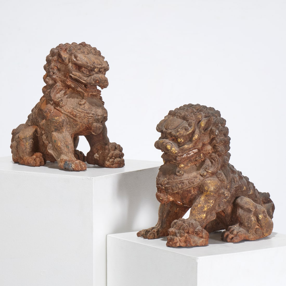 Pair Chinese cast iron Buddhist lions: Pair Chinese cast iron Buddhist lions, Late Qing Dynasty (19th/20th c.), China, gilt remnants, each approx. 13"h x 8"w x 14"d Provenance: A Private Collection: 115 Central Park West, NYC