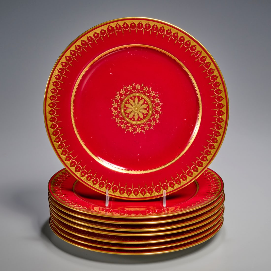 Set (8) Minton porcelain cabinet plates: Set (8) Minton porcelain cabinet plates, 20th c., England/USA, red crimson ground with parcel gilt decoration, marked underside, each 10"dia Provenance: A Private Collection: 1095 Park Avenue, NYC