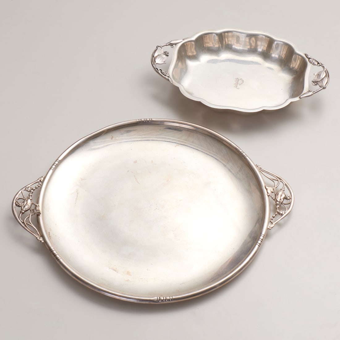 American sterling silver tray and serving dish: American sterling silver tray and serving dish, Mid 20th c., William Lawrence de Matteo round blossom tray, 13.75"dia; with, Durham floral handled serving dish, monogram to center, 1.5"h x 11.75"l x 7