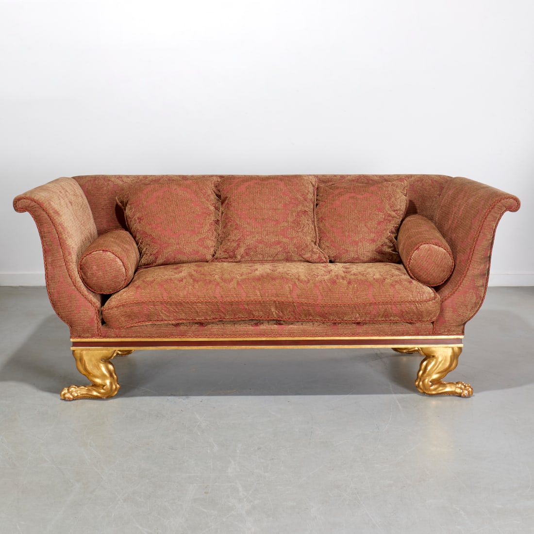 Quatrain for Dessin Fournir, Regency style sofa: Quatrain for Dessin Fournir, Regency style sofa, 21st c., fine quality, upholstered in luxurious sculpted gold and crimson fabric, three pillow back and single cushion seat, with bolster pillow to eac
