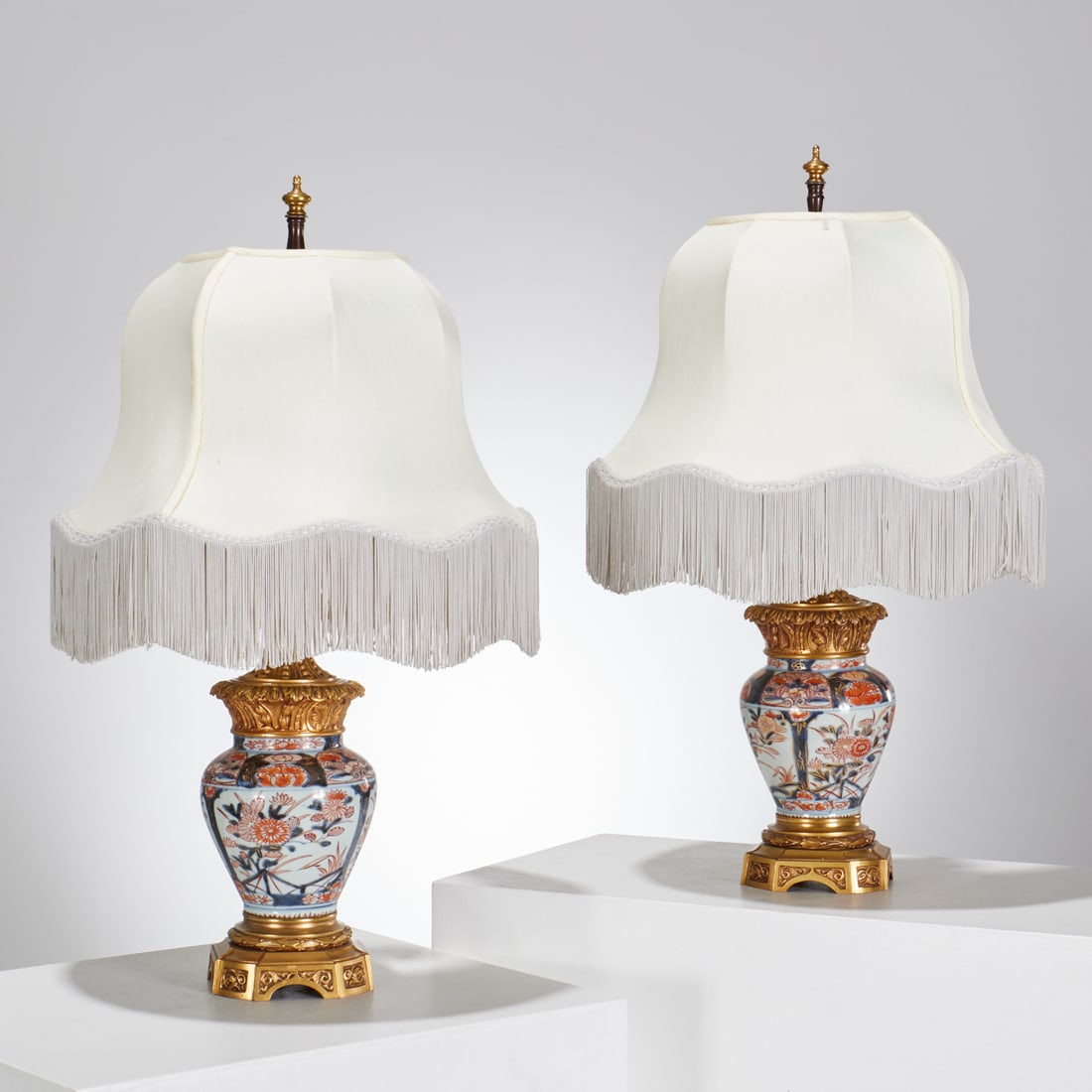 Pair Japanese Imari bronze mounted porcelain lamps: Pair Japanese Imari bronze mounted porcelain lamps, 19th c. and adapted, baluster shaped vessels with foliate-cast gilt bronze mounts, two-lights, each 25.25"h x 5.5"w (total) Provenance: A Private Co