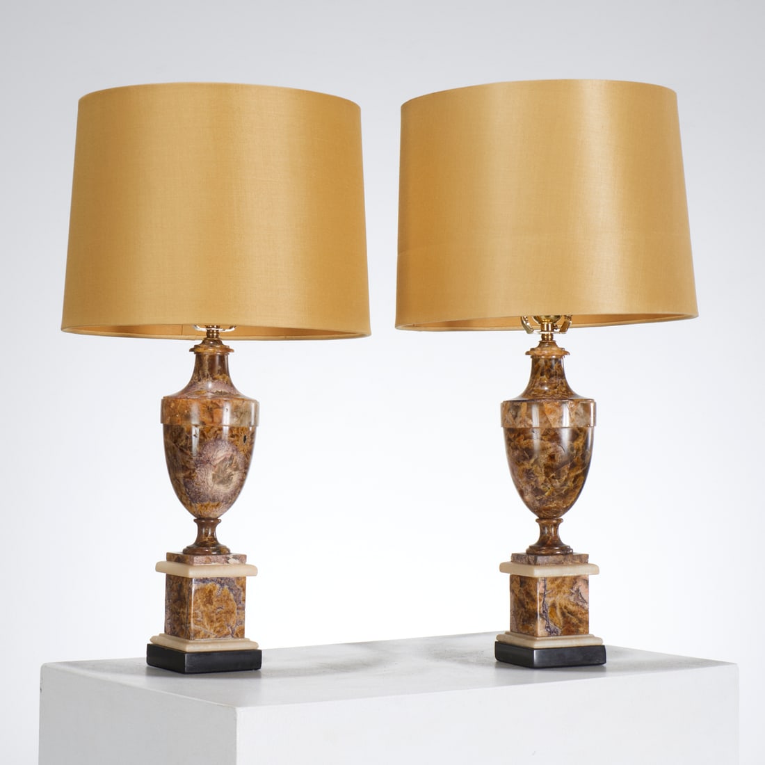 Pair English Blue John and marble lamps: Pair English Blue John and marble lamps, 19th c. and later, England, of urn form with stacked slate and marble base, unmarked, yellow silk drum shades, each 23"h x 12"dia (total), 16.5"h x 4"dia