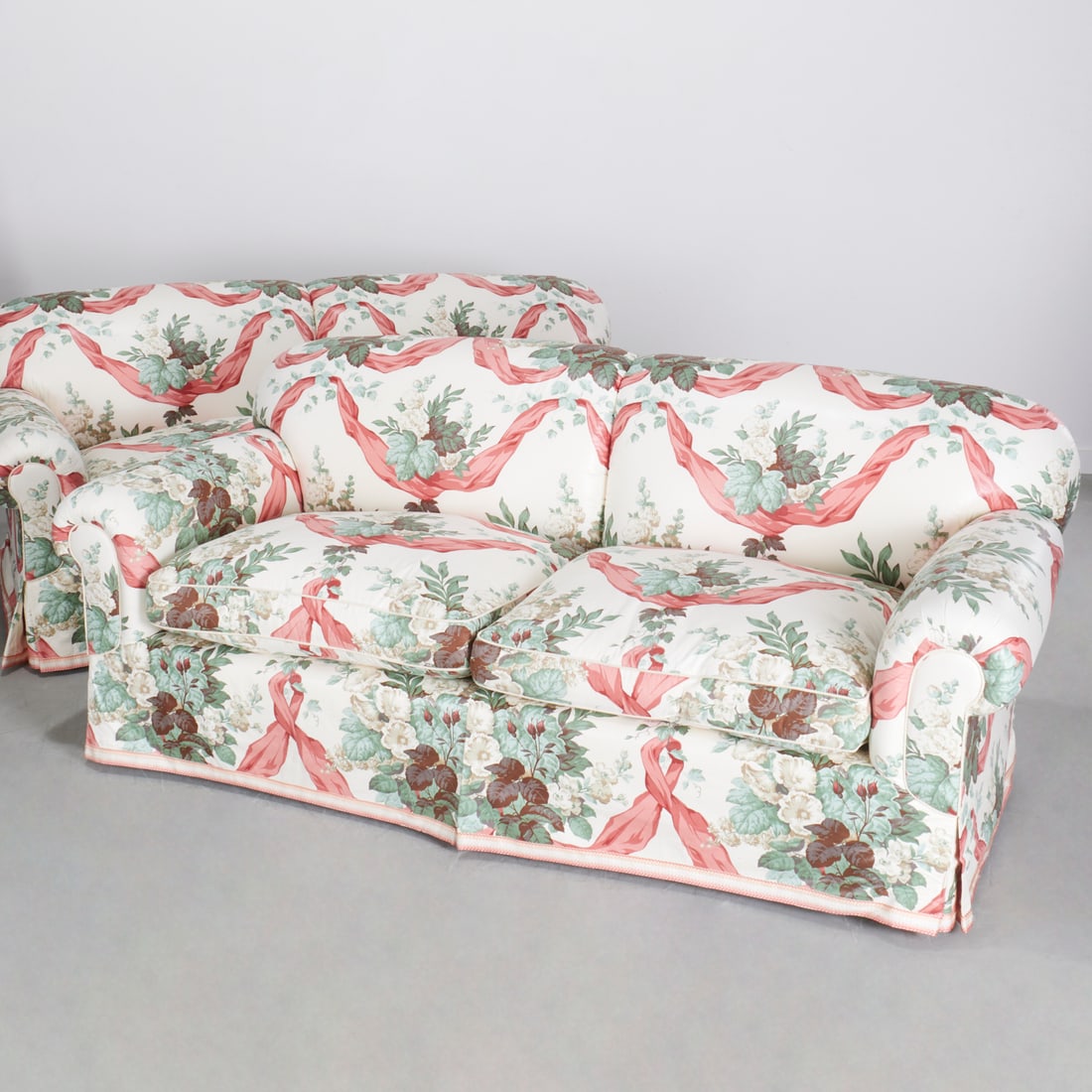 Pair Warner & Sons chintz upholstered loveseats: Pair Warner & Sons chintz upholstered loveseats, 20th c., Warner & Sons silk upholstery in hollyhock & swag pattern, unmarked, each approx. 31"h x 78"w x 37"d Provenance: A Private Collection: 22 Part