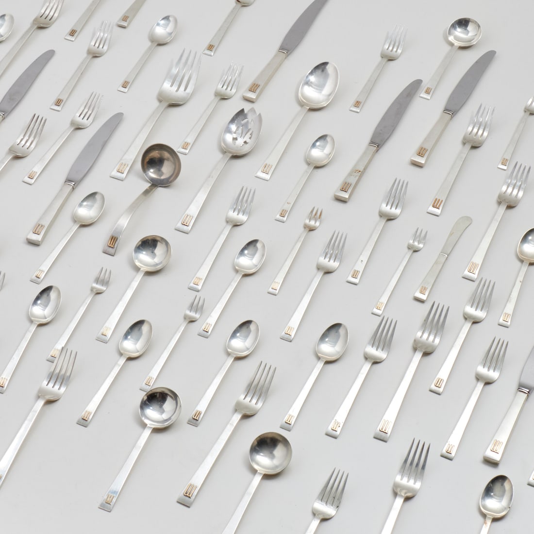 Assembled sterling flatware set: Assembled sterling flatware set, 20th c., USA, incl. International and Cartier, applied gold monogram "M", (114) pieces., incl. (12) dinner knives, (12) dinner forks, (12) soup spoons, (25) luncheon f