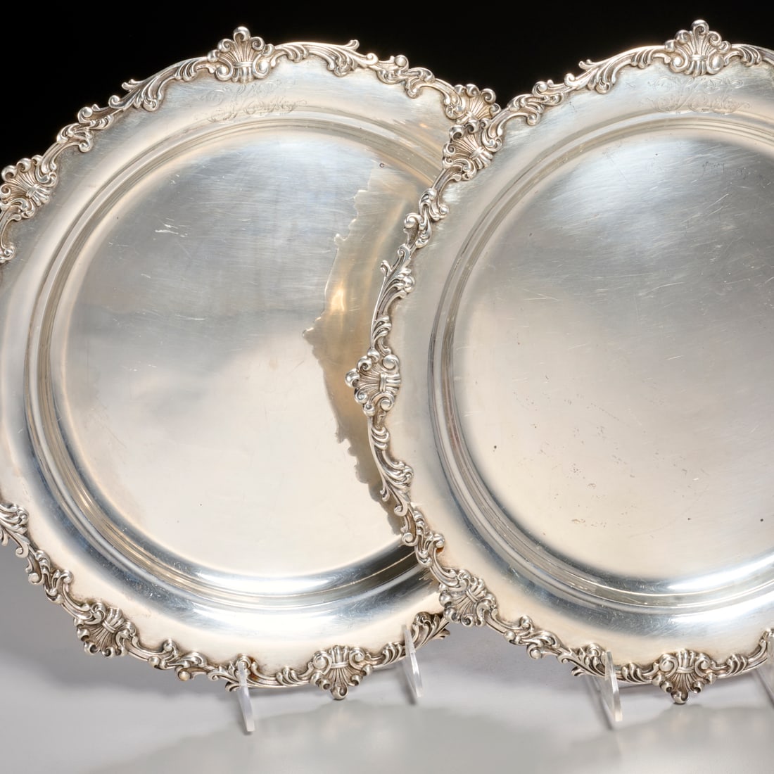 (2) Howard & Co. sterling silver chargers: (2) Howard & Co. sterling silver chargers, 1896-1897, New York, shell and scroll border, monogrammed edge, etched "April 4-1899" underside, each fully hallmarked underside, each 15"dia, approx.