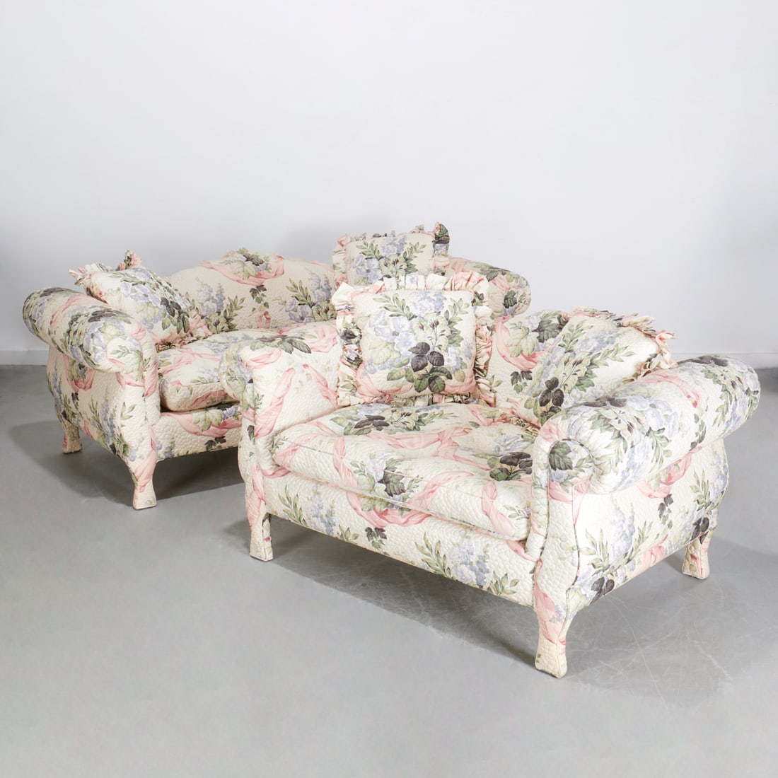 Custom quilted Chintz love seat and sofa: Custom quilted Chintz love seat and sofa, Mid 20th c., camelback frames, fully upholstered in pink, green, and lilac floral pattern on ivory ground, incl. (1) love seat, (1) sofa, 33"h x 85"w x 36"d