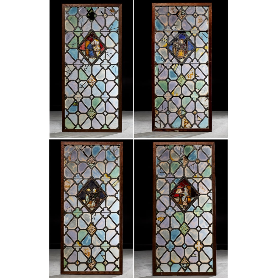(4) Gothic Revival stained leaded glass windows: (4) Gothic Revival stained leaded glass windows, 19th c. or earlier, each with central painted panel depicting scribes, in later oak frames, 54"h x 24"w (sight), 56.75"h x 26.5"w (frames) Provenance: