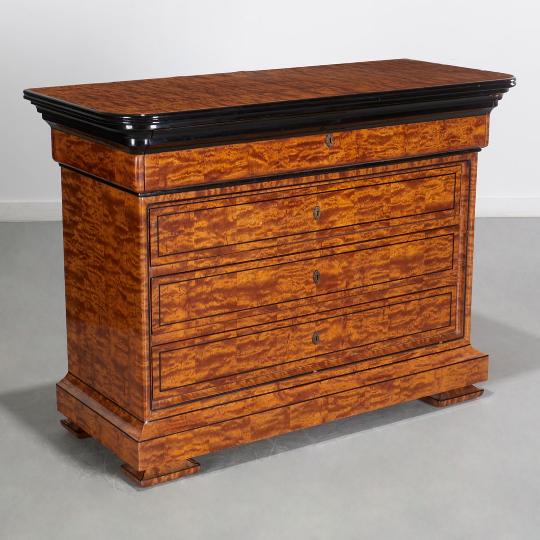 Enrique Garcel, burlwood commode: Enrique Garcel, burlwood commode, 20th c., Colombia, in the Louis Philippe style, parcel ebonized, with four drawers, on molded feet, label verso, 39"h x 52"w x 22"d Provenance: A Private Collection: