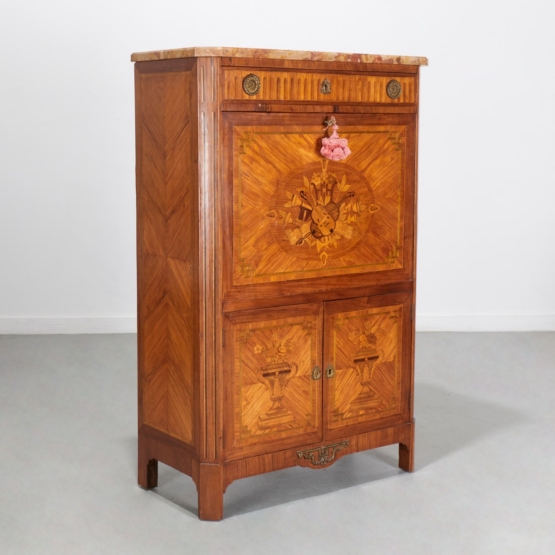 Louis XV/XVI marquetry secretaire a abattant: Louis XV/XVI marquetry secretaire a abattant, 19th c., France, breche d'alep marble top, over frieze drawer and fall-front secretary door with musical trophy, lower cupboard doors with flowering urn i