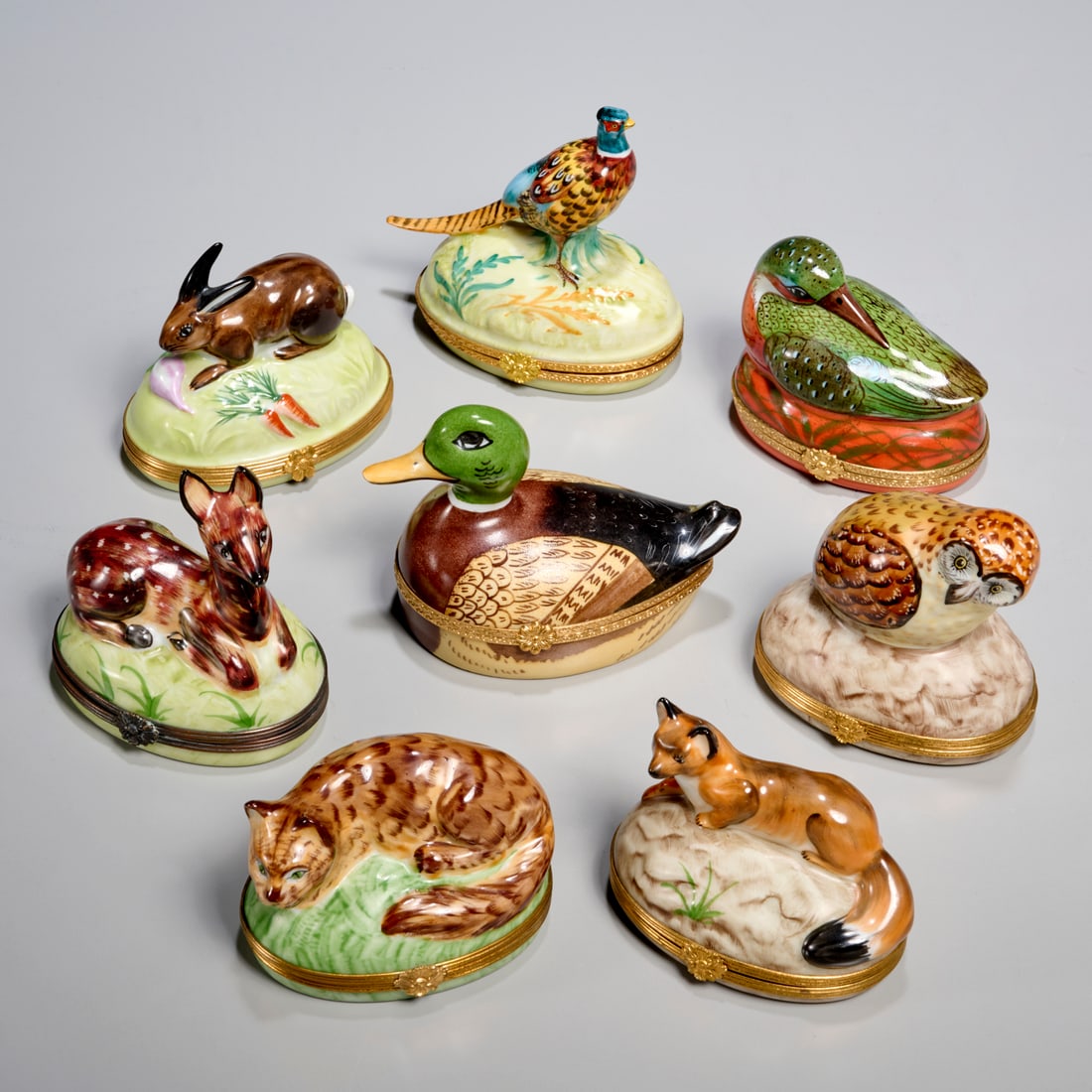 Tiffany & Co., (8) Limoges porcelain fauna boxes: Tiffany & Co., (8) Limoges porcelain fauna boxes, 20th c., France, hand-painted fox, duck, rabbit, pheasant, deer and owl forms, each marked underside, 4"h x 4"w x 2.5"d (largest), 2.5"h x 3.25"w x