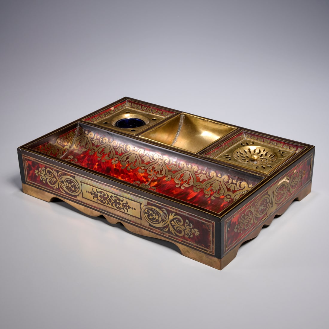 Louis XIV brass mounted boulle inkstand: Louis XIV brass mounted boulle inkstand, 17th/18th c. and adapted, France, of rectangular form with twin compartments, brass foliate inlay, on bracket feet, Paris transport label underside, 3"h x 14.2