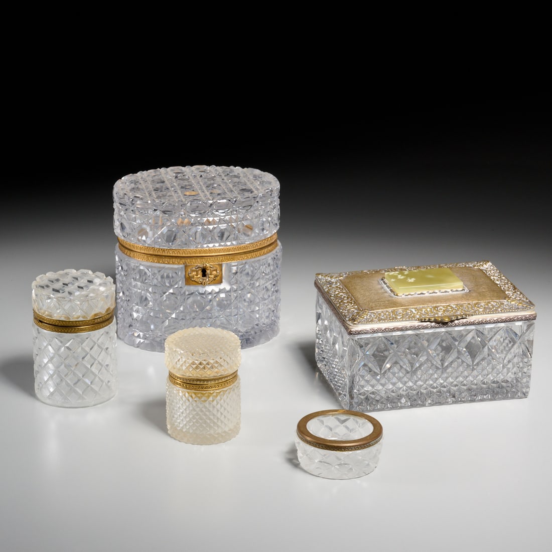 (5) Baccarat style brass mounted glass accessories: (5) Baccarat style brass mounted glass accessories, Mid 20th c., France, incl. (2) hinged boxes, (2) jars, (1) powder dish, some marked "Made in France" to interior bronze, 6"h x 6"w x 4.5"w (largest)