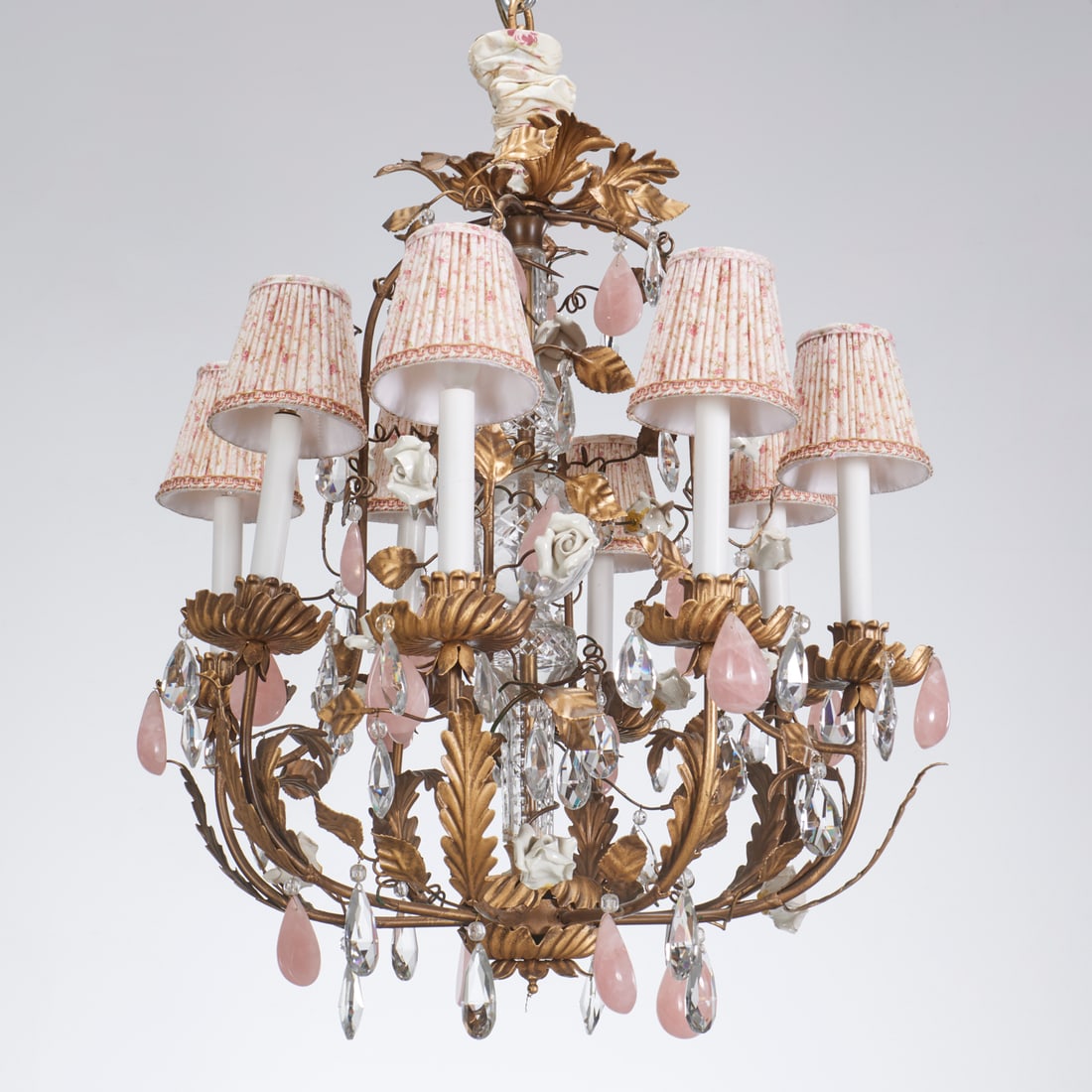French tole and porcelain chandelier: French tole and porcelain chandelier, 20th c., 8-lights, glass stem with tole leaves, glazed porcelain blossoms, and rose quartz drops, approx. 28"h x 23"dia Provenance: A Private Collection: Beachsid