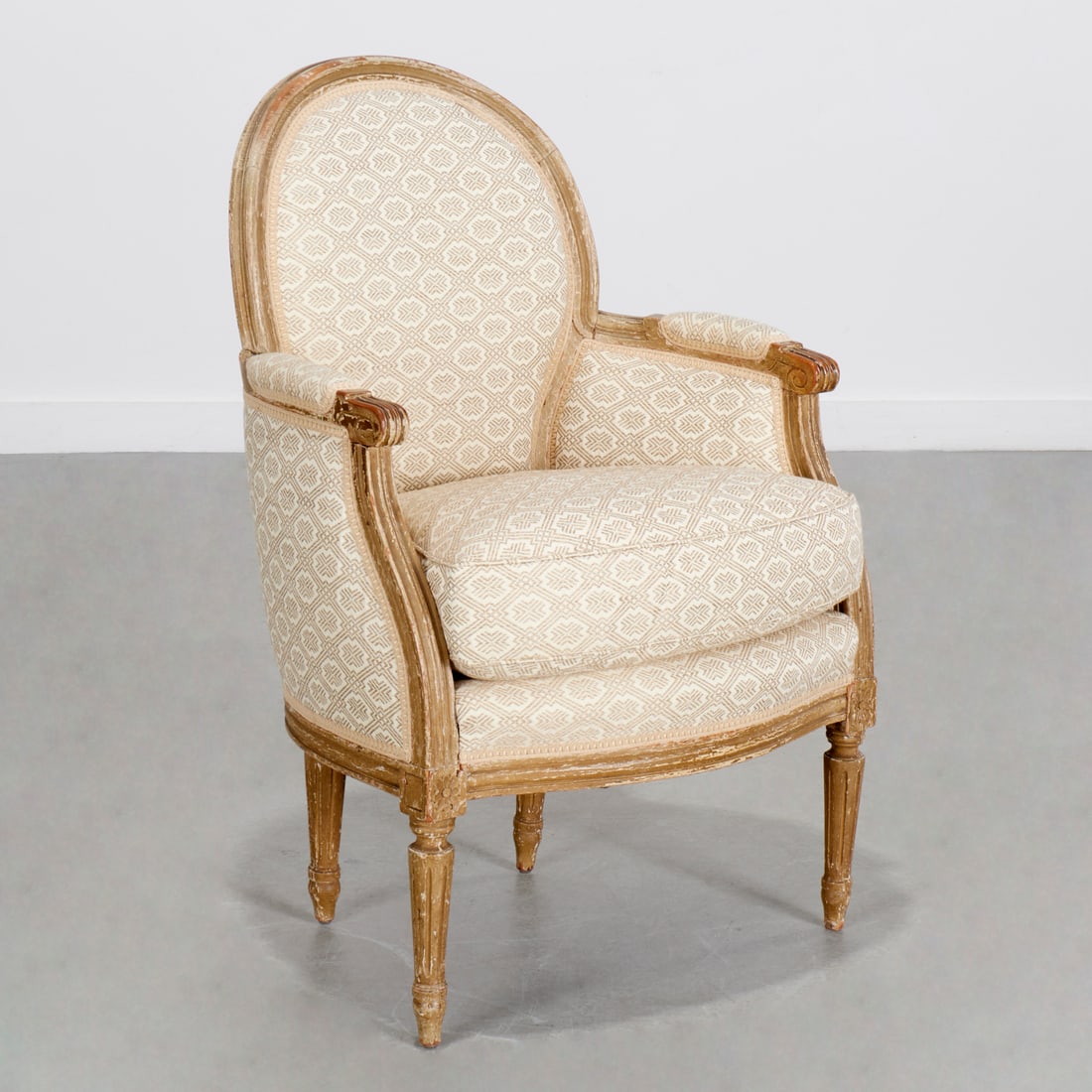 Antique Louis XVI style painted bergere: Antique Louis XVI style painted bergere, 19th c., France, green painted carved and channeled frame, scroll arms, serpentine front, raised on fluted legs, 35"h x 23"w x 19"d Provenance: Property from a