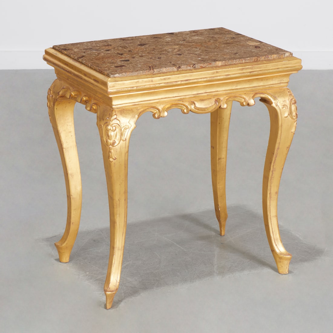 Louis XVI style giltwood side table: Louis XVI style giltwood side table, 20th c., nice quality, rectangular inset fossil marble top, over shaped skirt and cabriole legs, unmarked, 26.25"h x 23.5"w x 17"d Provenance: Property from a Prom