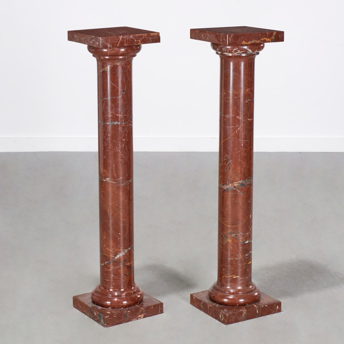 Pair Italian Rosso Antico marble pedestals: Pair Italian Rosso Antico marble pedestals, 19th/20th c., of column form with squared top and base, each 42.5"h x 10"squ Provenance: A Private Collection: 1150 Park Avenue, NYC