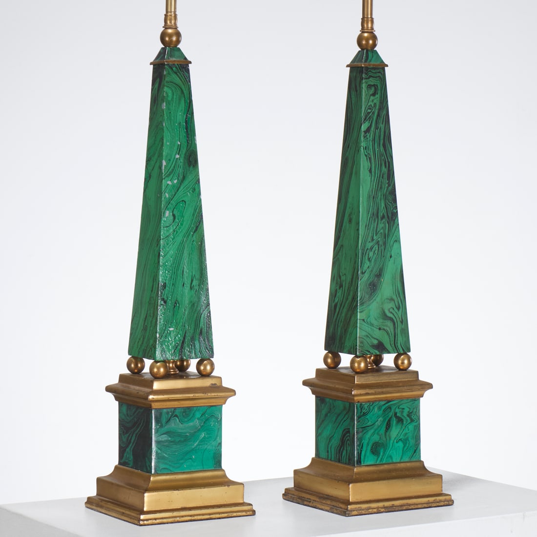 Paul Hansen (attrib), pair faux malachite lamps: Paul Hansen (attrib), pair faux malachite lamps, 20th c., painted metal obelisk on gilt bun feet, on plinth, unmarked, each 33.5"h x 5.75"squ Provenance: A Private Collection: Rumson, NJ
