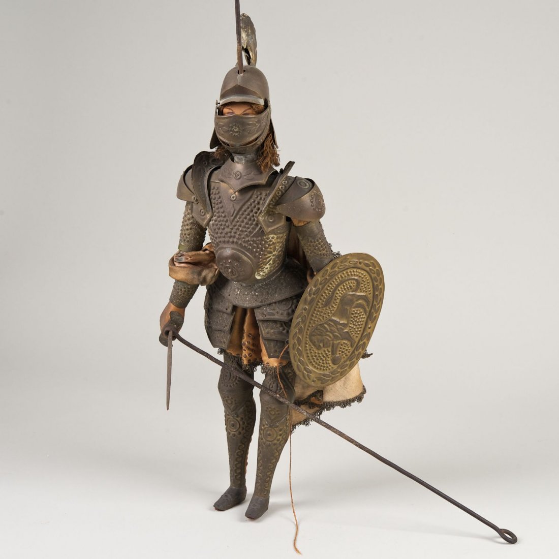 Antique Continental armored conquistador marionette: Antique Continental armored conquistador marionette: 19th/20th c., polychromed wood, silk and brass, 24"h x 8.5"w