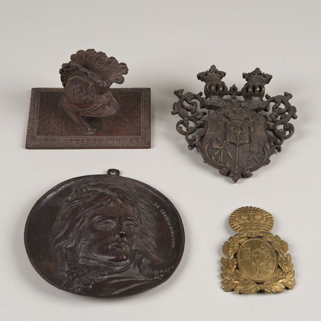 (4) Napoleonic, armorial and military bronzes: (4) Napoleonic, armorial and military bronzes: 19th c., incl. (2) armorials, patinated iron helmet paperweight, and Napoleon plaque signed and dated "David 1839?" (P.J.D. d'Angers), plaque: 6.25"dia.