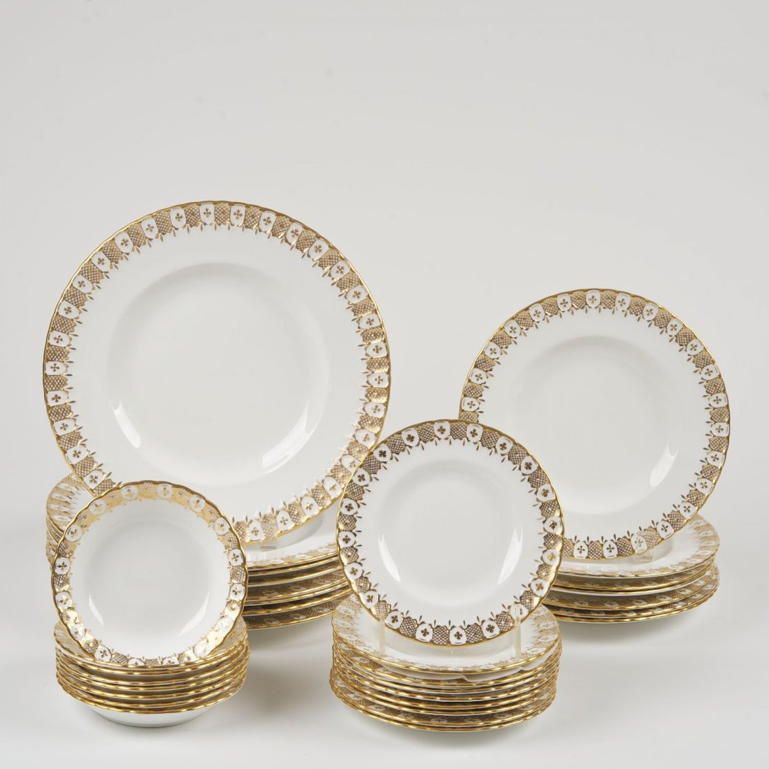 Royal Crown Derby porcelain part dinner service: Royal Crown Derby porcelain part dinner service: 20th c., "Heraldic Gold" pattern, (8) dinner plates, (7) dessert/salad plates, (9) bread dishes, (8) fruit bowls and (3) cups, dinner plates: 10.5"dia.