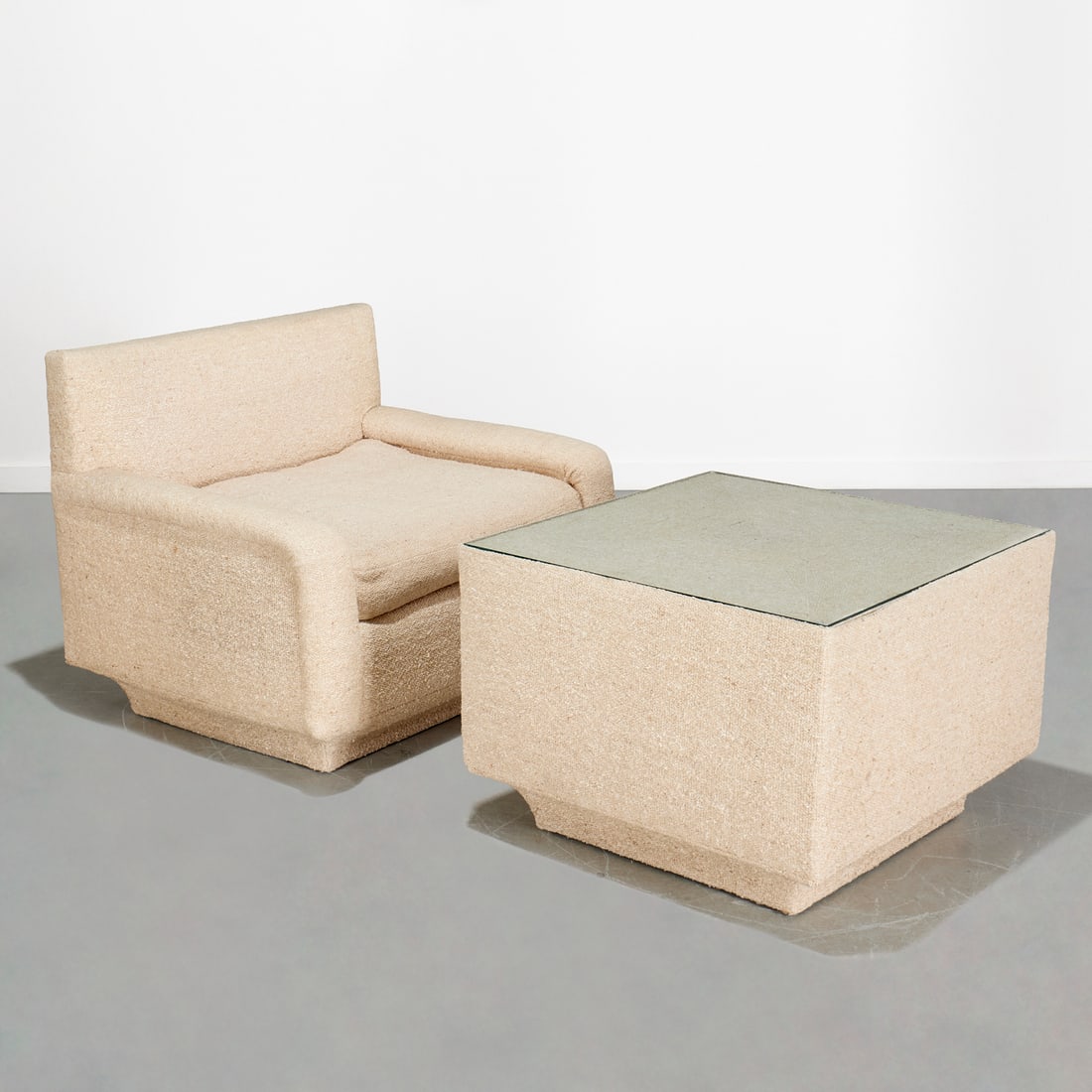 Milo Baughman (style), club chair and coffee table: Milo Baughman (style), club chair and coffee table, Late 20th c., oatmeal upholstered, incl. (1) modular club chair on casters (1) glass top and upholstered coffee table, unmarked, 33"h x 40"w x 33"d 
